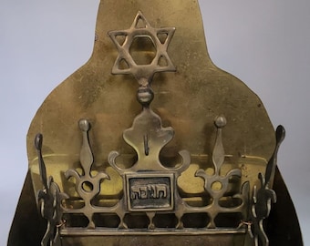 An original and beautiful Dutch menorah from the 19th century with the original vessel for collecting the oil.