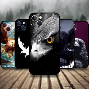 May include: A selection of phone cases showcasing eagle artwork. The cases feature diverse eagle designs, such as a detailed close-up of an eagle's face with a yellow eye, a white silhouette, and other artistic illustrations.
