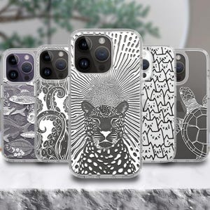 May include: A collection of clear phone cases with various black and white designs. The designs include a leopard, fish, octopus tentacles, cat pattern, and a turtle. The cases are displayed on a light-colored surface.