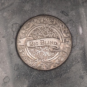May include: A silver-coloured metal medallion with an ornate design and the words "Big Band" on a ribbon.