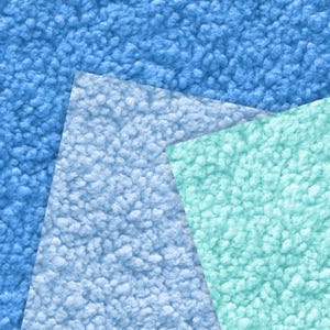 May include: A textured image featuring three overlapping sections of fabric in shades of blue and teal. The textures appear soft and plush, with a dense, fuzzy surface. The arrangement creates a layered, abstract design.