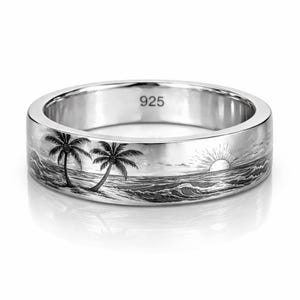 May include: A silver ring with a detailed engraved design of a tropical beach scene. The ring features two palm trees, ocean waves, and a setting sun. The number "925" is stamped on the ring.