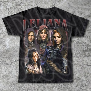 May include: Black t-shirt with a graphic print of a woman with a raven. The text "LELIANA" is printed in white letters across the top of the shirt.