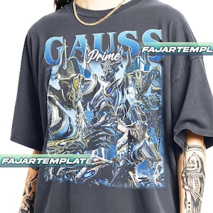 May include: Dark gray t-shirt featuring a blue and silver graphic design with the text "GAUSS Prime". The design includes multiple figures with a futuristic aesthetic. The shirt has short sleeves and a relaxed fit.