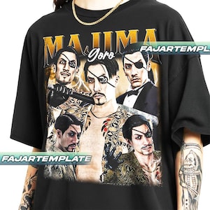 May include: Black t-shirt featuring a graphic of a man with an eye patch, with the word "MAJIMA" in gold lettering above the image. The word "Goro" is written in cursive. The shirt has a crew neck and short sleeves.