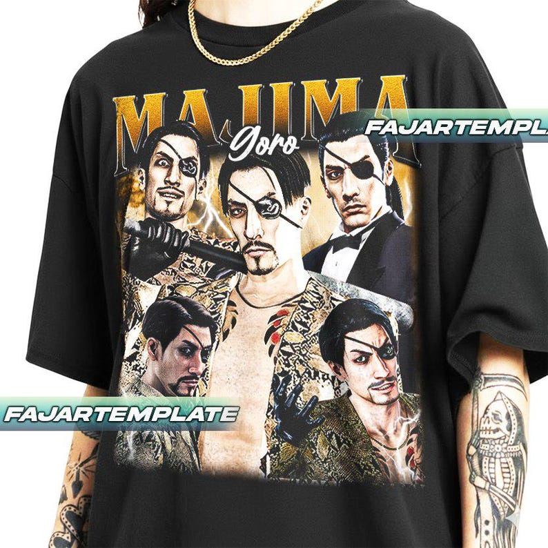 May include: Black t-shirt featuring a graphic of a man with an eye patch, with the word "MAJIMA" in gold lettering above the image. The word "Goro" is written in cursive. The shirt has a crew neck and short sleeves.