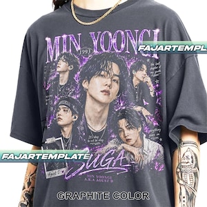 May include: A charcoal gray short-sleeve t-shirt featuring a graphic print of Min Yoongi. The design includes multiple portraits of the artist, the text "MIN YOONGI", "SUGA", "1993", "Agust D", and "Everything goes on" in purple and white.