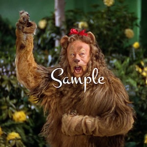 May include: A Cowardly Lion costume with a red bow, worn by a person with a surprised expression. The lion costume is made of brown fur and has a mane. The person is standing in front of a green background with yellow flowers.