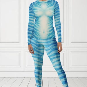 May include: A blue and white patterned long-sleeve shirt and leggings set. The outfit features a design that resembles stripes. The text "MAX(XX)ART" is visible in the top left corner. The words "SOLD SEPARATELY" are in a circle in the bottom right corner.