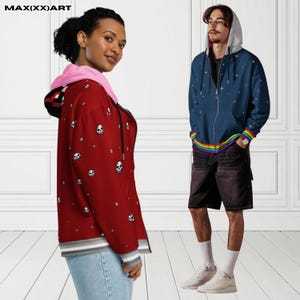 May include: Two zip-up hoodies. One is red with white skull graphics, a pink hood lining, and a gray and white striped hem. The other is navy blue with a star pattern, a rainbow trim, and a gray hood. The brand name "MAX(XX)ART" is visible.