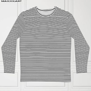 Puede incluir: Una camiseta de manga larga con rayas horizontales en blanco y negro. La camiseta tiene cuello redondo. La prenda se muestra plana sobre un fondo blanco. El material parece ser de punto suave.