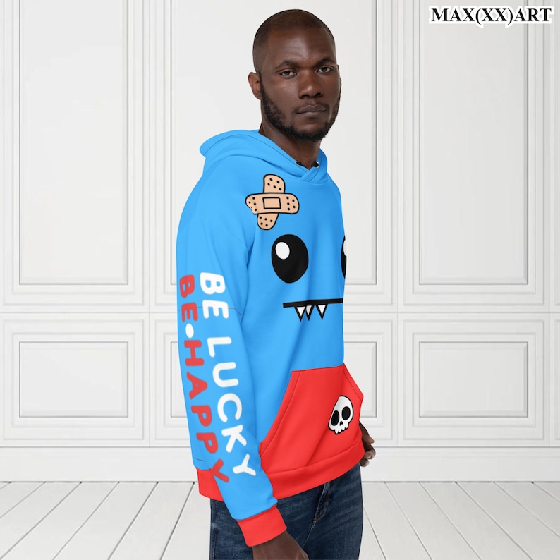 May include: A blue and red hoodie with a cartoon face on the front. The hoodie has the words "Be Lucky Be Happy" printed on the sleeves.