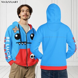 May include: Blue and red zip-up hoodie featuring a cartoon character on the front. The character has a plaster on its head, large eyes, and a toothy grin. The text "Be Luck Be Happ" is on the left sleeve.