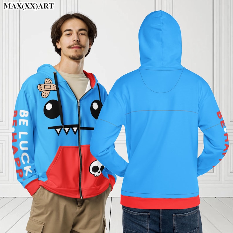May include: Blue and red zip-up hoodie featuring a cartoon character on the front. The character has a plaster on its head, large eyes, and a toothy grin. The text "Be Luck Be Happ" is on the left sleeve.