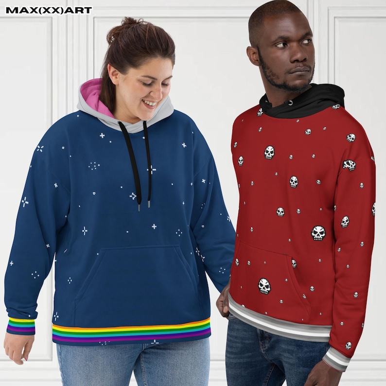 May include: Two hooded sweatshirts. One is navy blue with a white star pattern and a rainbow stripe at the bottom. The other is red with a white skull pattern. Both have a front pocket and drawstrings.