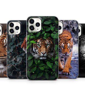 May include: Four different phone cases featuring tiger designs. The cases are all black and feature different images of tigers in various settings. One case features a tiger in a jungle setting, another features a tiger in a more abstract setting, and the other two feature tigers in more realistic settings.