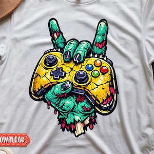 May include: White t-shirt featuring a graphic of a zombie hand holding a yellow and black video game controller. The zombie hand is green with red accents. The controller has colorful buttons. The words "DIGITAL DOWNLOADS" are at the bottom.