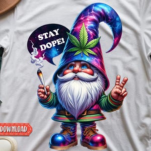 May include: White t-shirt featuring a colorful gnome with a long white beard, holding a lit item and giving a peace sign. The gnome wears a hat with a cannabis leaf and the text "STAY DOPE!" in a speech bubble. Digital download.