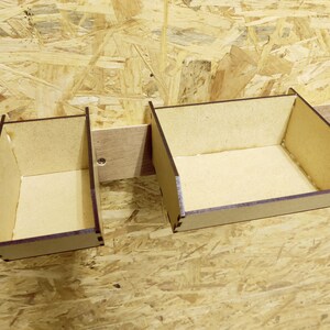 May include: Two wooden storage boxes with brown stained edges, mounted on a wall. The boxes are empty and ready to be filled with items.