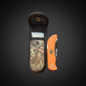 May include: An orange folding knife with a black handle and the text "RAZOR-PRO" is next to a black sheath with a camouflage pattern. The sheath has a snap closure and is open, revealing a small item inside.