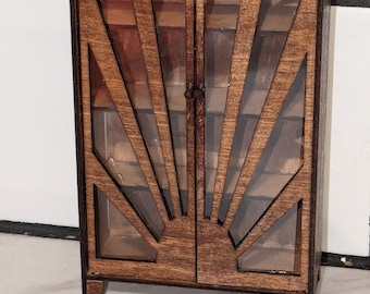 May include: A wooden cabinet with glass doors and a sunburst design. The cabinet has a dark brown stain and is made of wood.