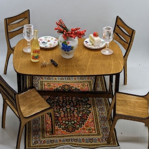 May include: A wooden dining table set with four chairs, a bottle of wine, two wine glasses, a plate of cake, a vase with red berries, and a rug with a floral pattern.
