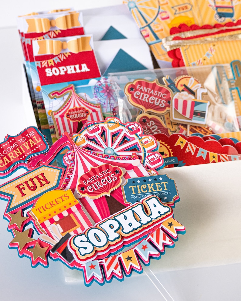 May include: A set of colorful carnival-themed party decorations with the name "Sophia" on a red and white striped tent, a ticket booth, and a Ferris wheel. The decorations are perfect for a birthday party or other celebration.