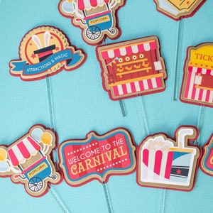 May include: A set of 8 carnival themed cupcake toppers. The toppers feature images of popcorn stands, a ticket booth, a shooting gallery, a magic show, and a welcome to the carnival sign. The toppers are printed on cardstock and have red, white, and blue accents.