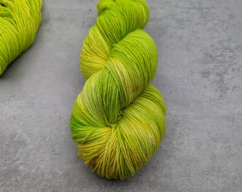 Hand-dyed sock yarn neon green with speckles in 100gr skein