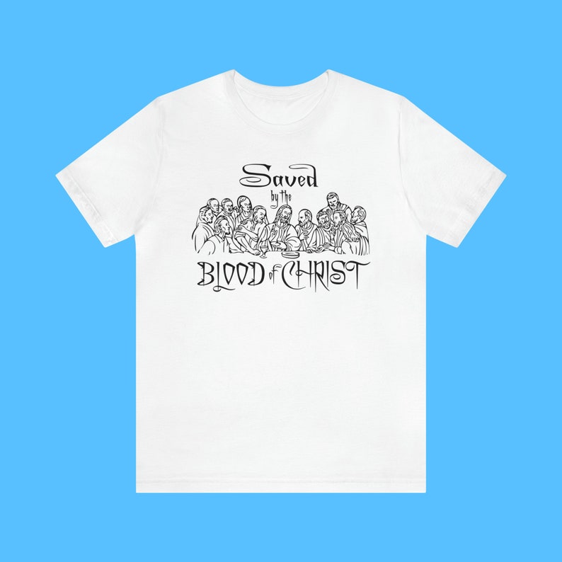 May include: White t-shirt featuring a black and white illustration of the Last Supper and the text "Saved by the Blood of Christ".