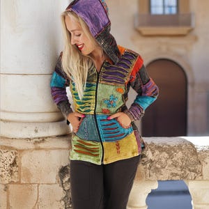 May include: A colourful patchwork hooded jacket with a zip closure. The jacket is made of different fabrics and has a variety of embroidery details.