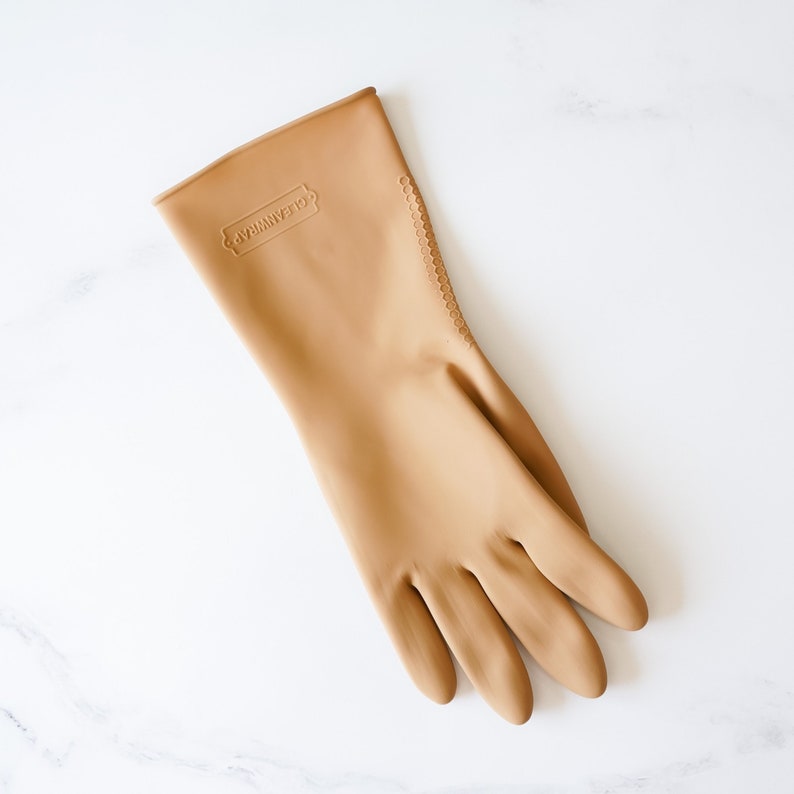 May include: A tan rubber cleaning glove with the word "CLEANMAGIC" embossed on the back.