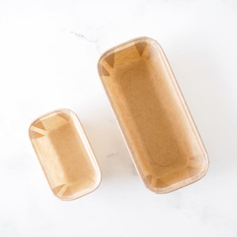Two rectangular kraft paper molds on a white background