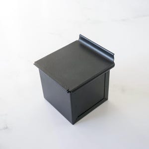 Black metal square bread loaf pan on a white background