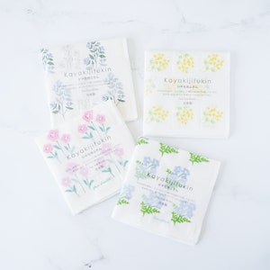 dish cloths, kitchen towelsFour square white fabric dishcloths with different floral prints arranged in a 2x2 grid on a white background. Dishcloth 1 has pink flowers, dishcloth 2 has blue flowers, cloth 3 has red strawberries, and cloth 4 has pink daisies.