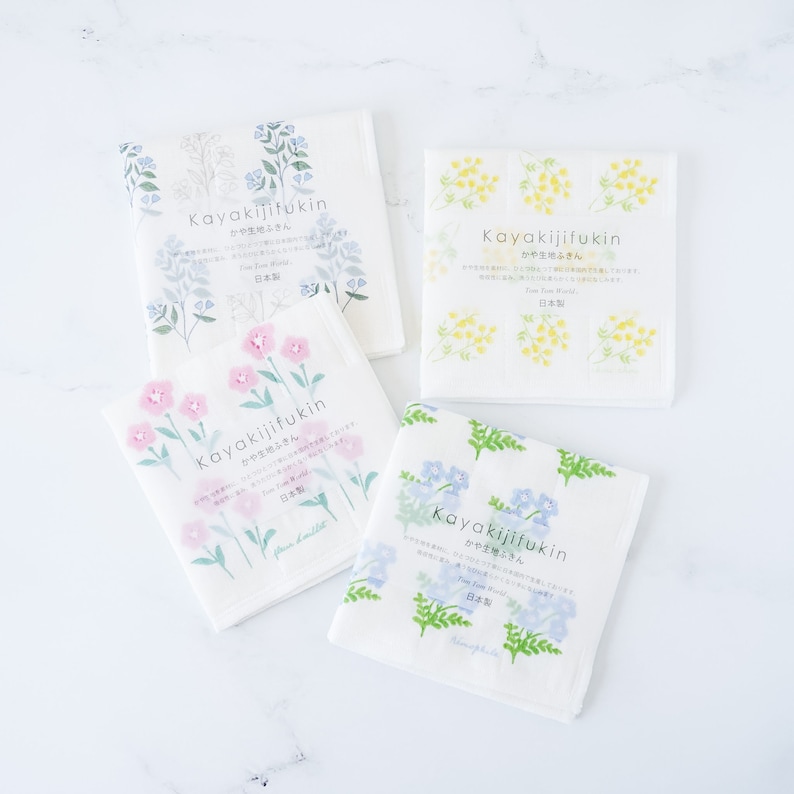 dish cloths, kitchen towelsFour square white fabric dishcloths with different floral prints arranged in a 2x2 grid on a white background. Dishcloth 1 has pink flowers, dishcloth 2 has blue flowers, cloth 3 has red strawberries, and cloth 4 has pink daisies.