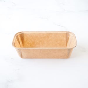 Rectangular paper bread loaf pan on a white background