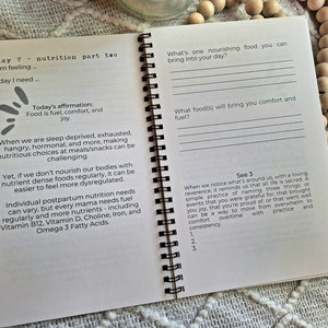 May include: An open spiral-bound journal with a white background and black text. The page is titled "Day 7 - Nutrition Part Two" and includes prompts for self-reflection on nutrition and wellbeing.