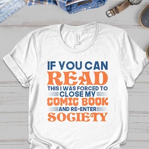 May include: White t-shirt with a blue and orange graphic that reads "If you can read this I was forced to close my comic book and re-enter society."
