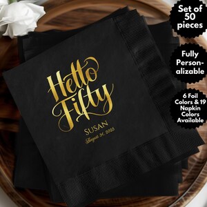 May include: Black napkins with gold foil lettering that reads "Hello Fifty" and "Susan August 31, 2025".  The napkins are part of a set of 50.