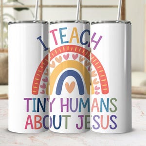 May include: Three white stainless steel tumblers with a rainbow and the text "I Teach Tiny Humans About Jesus".