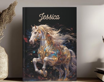 May include: A hardcover journal with a black cover featuring a white horse in a rearing pose. The horse is adorned with intricate gold and blue celestial-inspired patterns. The name Jessica is printed in a white script font at the top center.