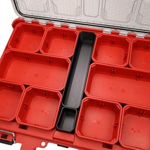 May include: A red and black plastic organiser with multiple compartments. The organiser has a clear lid and is designed to hold small items. The compartments are various sizes and shapes, providing versatile storage options.