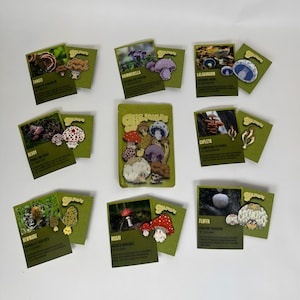 May include: A set of three ceramic mugs with a speckled, matte finish. The mugs are in shades of cream, light gray, and dark gray. Each mug has a simple, minimalist design, perfect for coffee or tea.