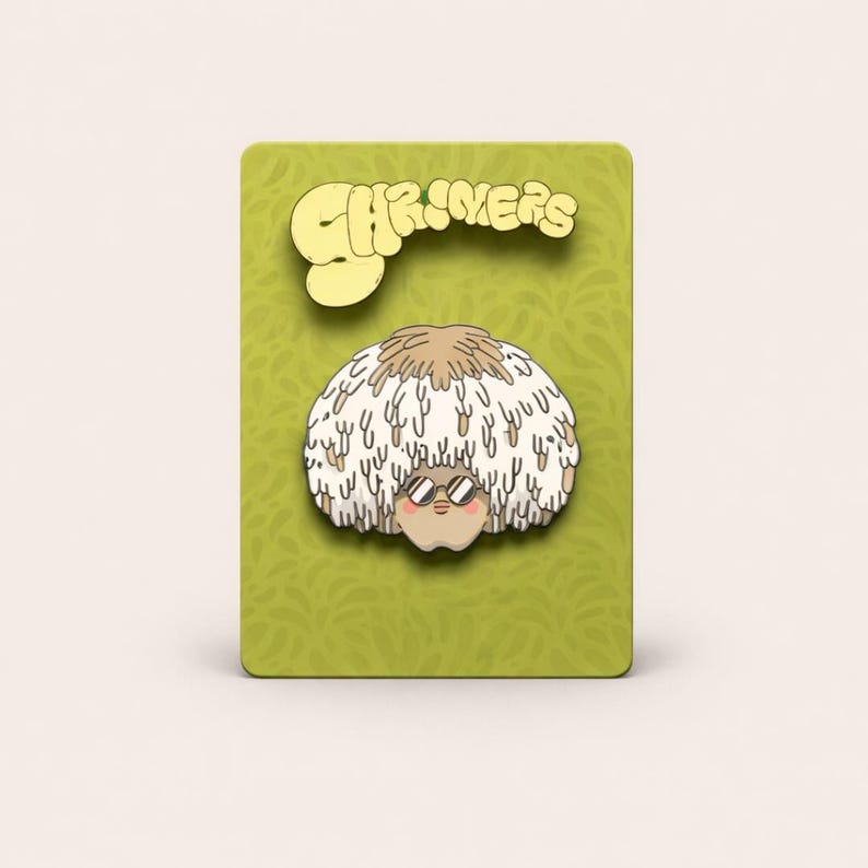 May include: A whimsical pin featuring a cartoon character with a fluffy, white and brown afro and sunglasses. The pin is set against a green background with the word "SHRIMERS" in a yellow, stylized font.