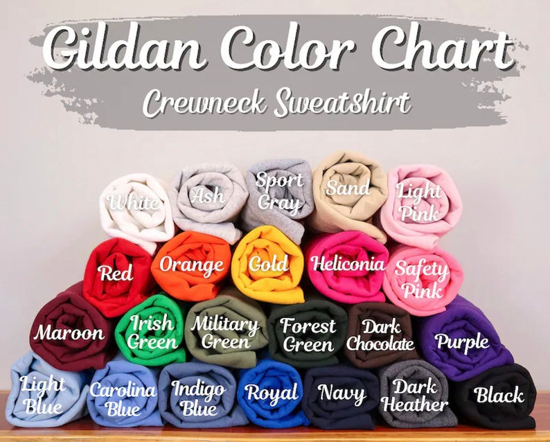 May include: A color chart for Gildan crewneck sweatshirts. The chart shows 18 different colors, including white, ash, sport gray, sand, light pink, red, orange, gold, heliconia, safety pink, maroon, Irish green, military green, forest green, dark chocolate, purple, light blue, Carolina blue, indigo blue, royal blue, navy, dark heather, and black.