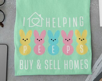 May include: A light green t-shirt with the text "I ♥ HELPING PEEPS BUY & SELL HOMES" and a row of five yellow, pink, blue, pink, and yellow marshmallow Peeps.