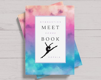 May include: A blue, pink, and purple watercolor book cover with a silhouette of a gymnast. The text on the cover reads "Gymnastics Meet Score Book" and "Sophia".