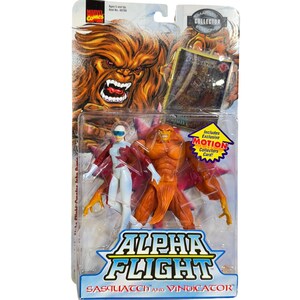 May include: A Marvel Comics Alpha Flight action figure set featuring Sasquatch and Vindicator in original blister packaging. The package includes an exclusive motion collector card and displays the characters with their names printed at the bottom.