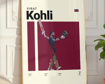 May include: A framed poster featuring Virat Kohli, with his name in bold black letters. The poster has a cream background with a burgundy rectangle behind a photo of Kohli holding a cricket bat and helmet. The poster is in a gold frame.